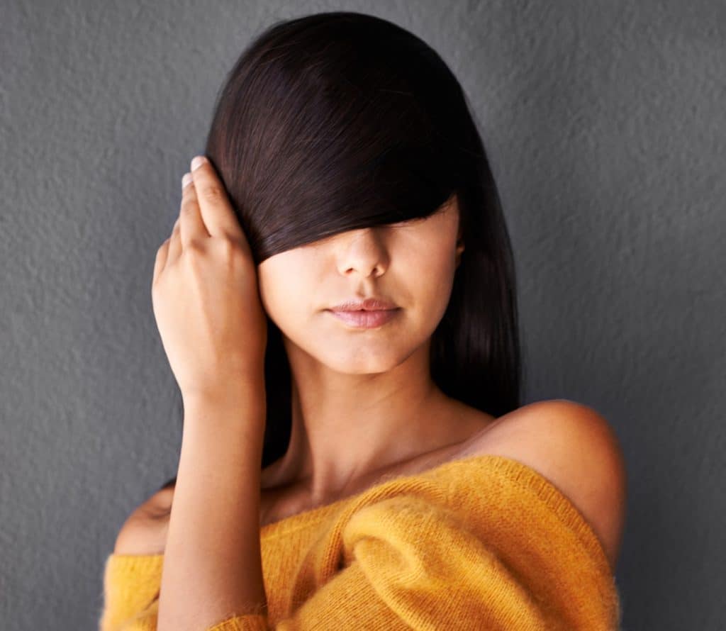 Closeup shot of an attractive young woman covering her eyes with her hairhttp://195.154.178.81/DATA/i_collage/pi/shoots/783562.jpg